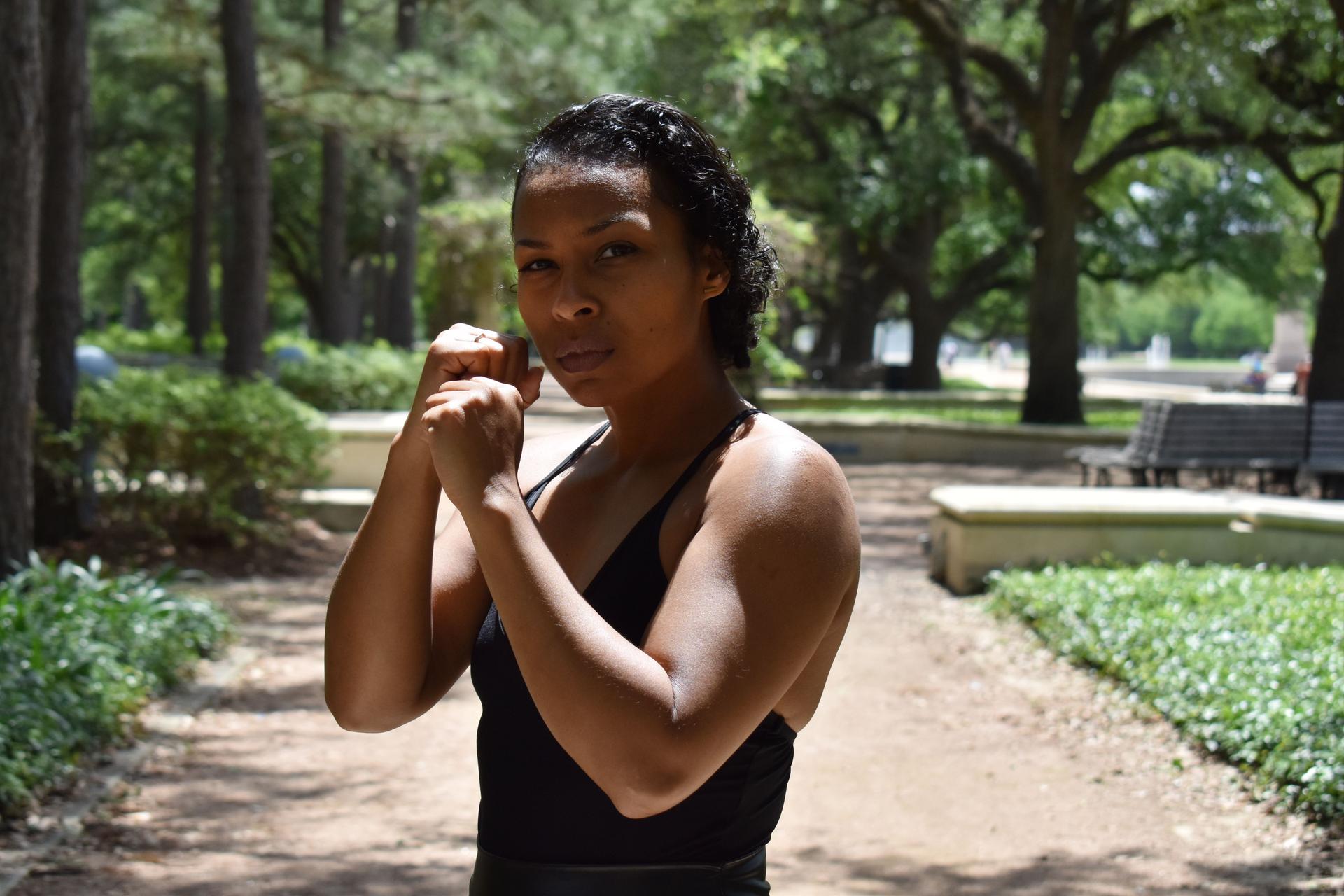 Beautiful woman of color and martial artist practicing self-defense in a national park
